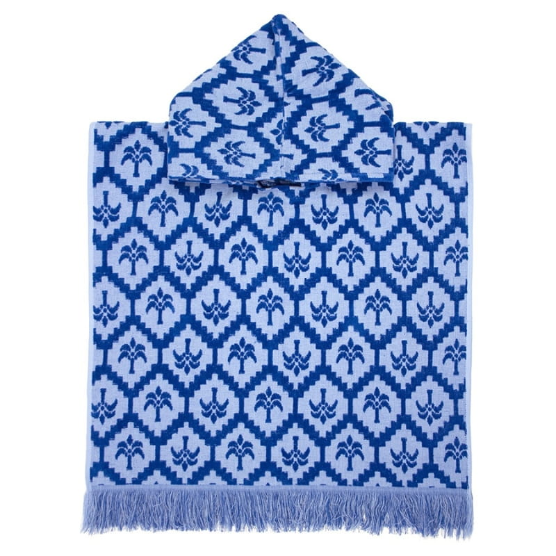 alt="Kids blue poncho featuring a stylish palm tree pattern with knotted tassels along the ends"