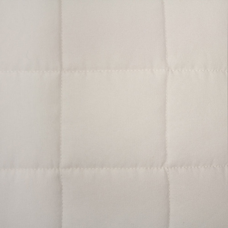 alt="Close-up view of a durable and soft microfibre fabric with quilted checks, neutral colour"