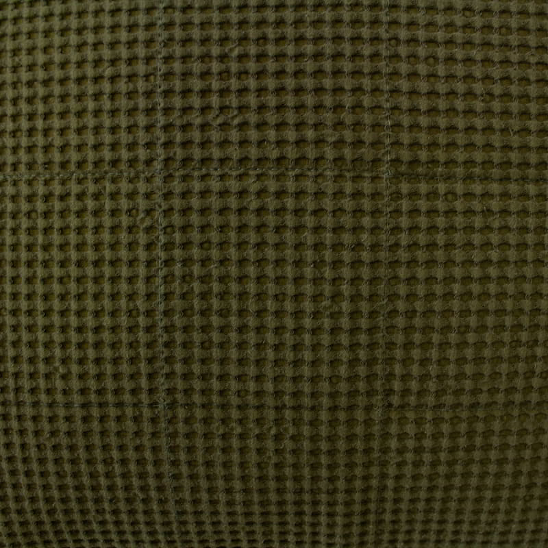 Cotton waffle fabric texture in olive green on european pillowcase.