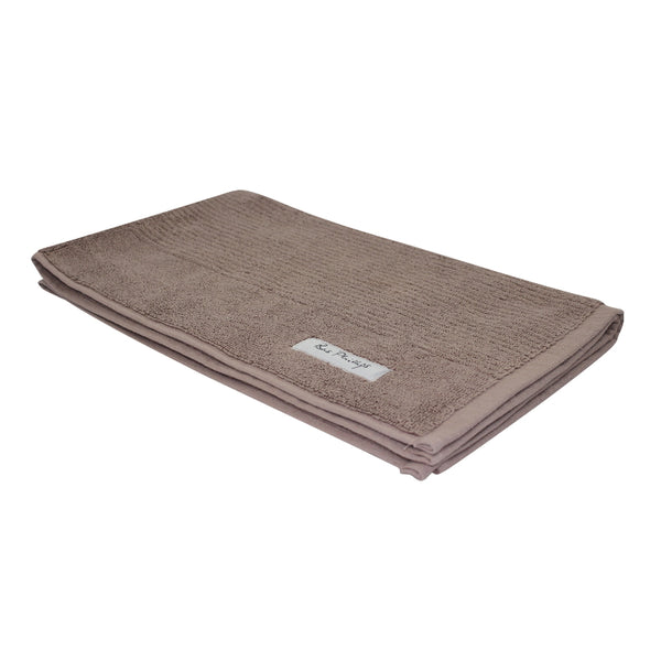 Brown egyptian bath mat showcasing a delightful design in intricate detail.