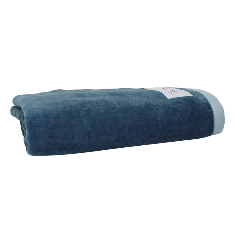 alt="A neatly rolled Denim California bath towel showcasing its cottony texture and premium-quality cotton"