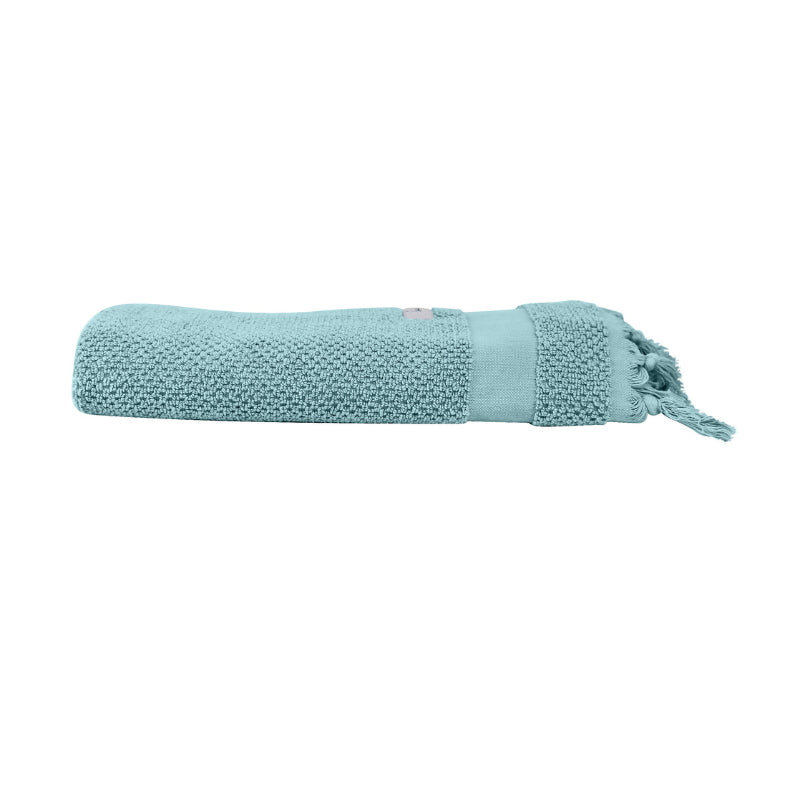 alt="An elegantly folded blue hand towel, showcasing its minimal details"