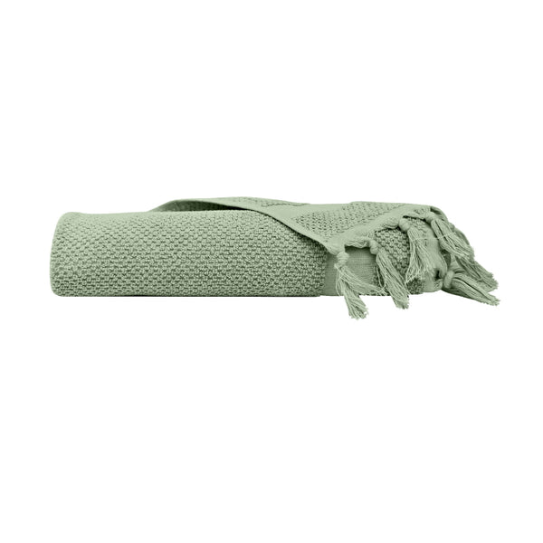 alt="An elegantly folded green hand towel, showcasing its minimal and soft details"