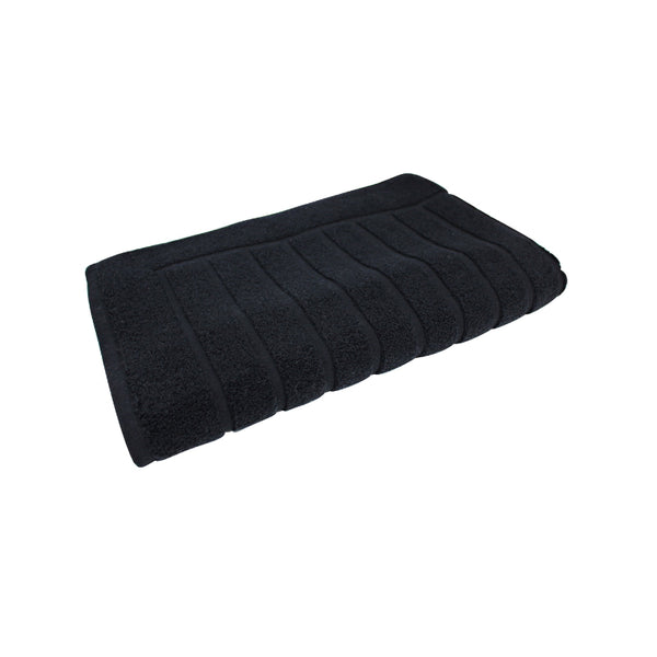 alt="The black Valencia Zero Twist bath mat unveils intricate folded details, adding a luxurious touch to your bathroom"