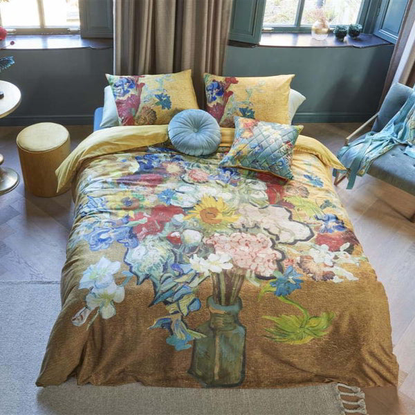 alt="A quilt cover featuring a bouquet of cut flowers from famous Van Gogh paintings on a golden background, with a solid golden-yellow underside."