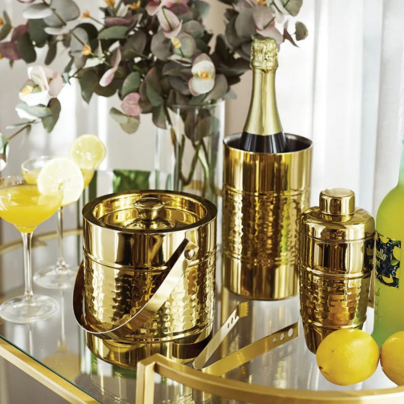 alt="A stunning hammered gold wine cooler surrounded by other collections featuring its high-quality."