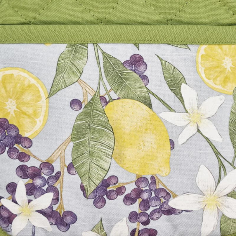 alt=" a close-up details of a green printed fabric showing lemon and flower prints"