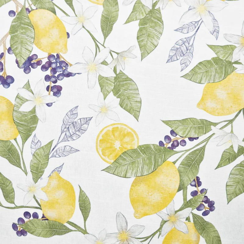 alt="a close-up details of a white fabric printed with yellow lemons, white flowers and purple fruits"