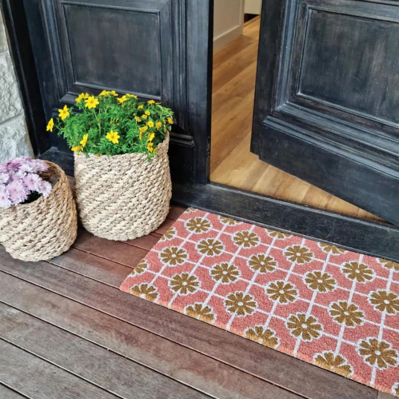 alt="A geo flower coir mat in front of door featuring its high quality coir materials and unique designs."