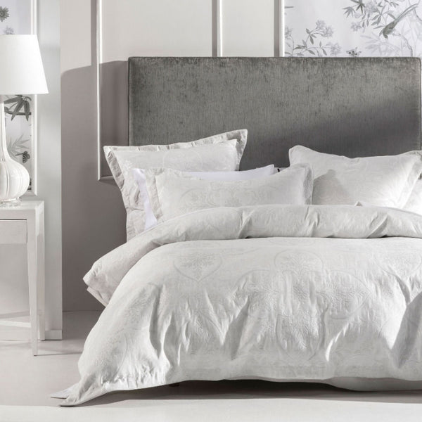 alt="Silver quilt cover set designed with a shimmering jacquard in a bedroom"