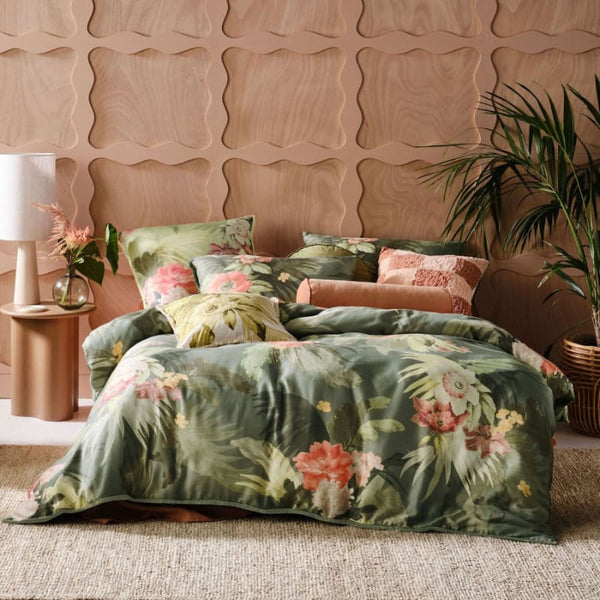 alt="A cotton quilt cover set outlined an archival tropical print in a cosy bedroom"