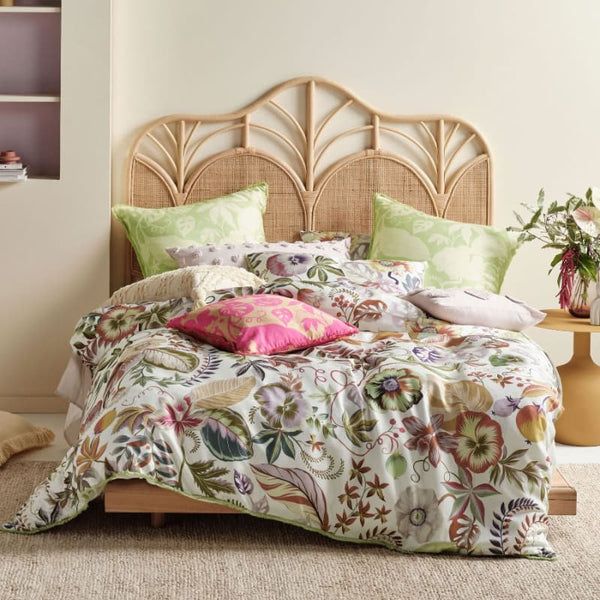 alt="A hyper-coloured eden of pattern quilt cover set in a luxurious bedroom"
