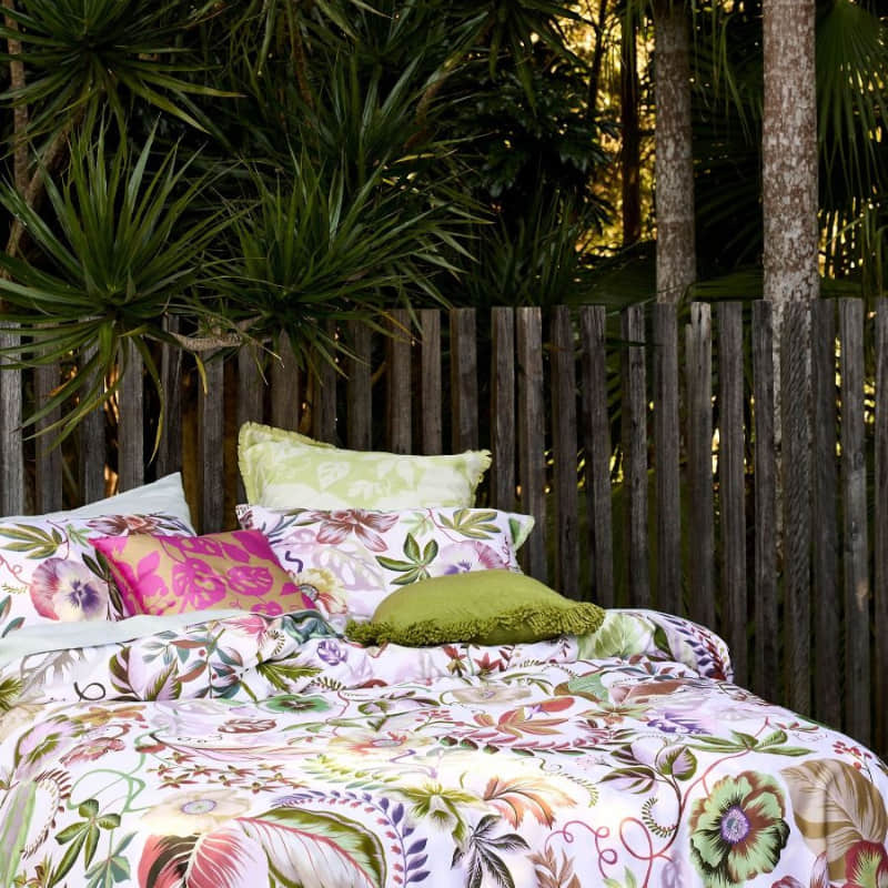 alt="Closer look of a detailed hyper-coloured eden of pattern quilt cover set in a luxurious bedroom"