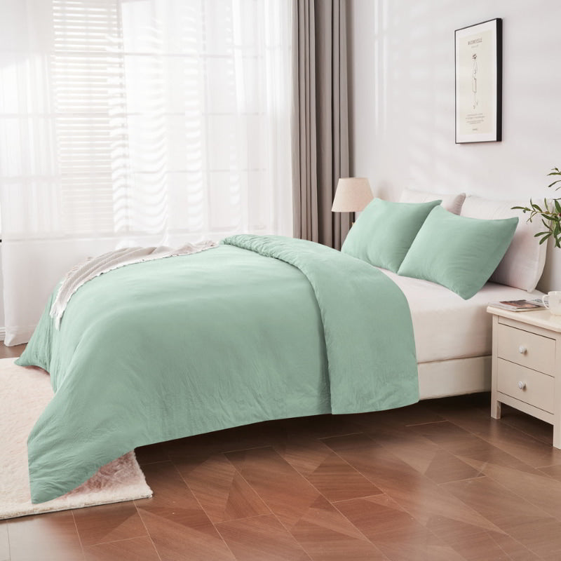 alt="Side view of an elegant sage green quilt cover set displayed on a bed, enhancing bedroom luxury and comfort"