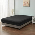 alt="An ultra-soft cotton blend black fitted sheet with deep pocket in a cosy bedroom"
