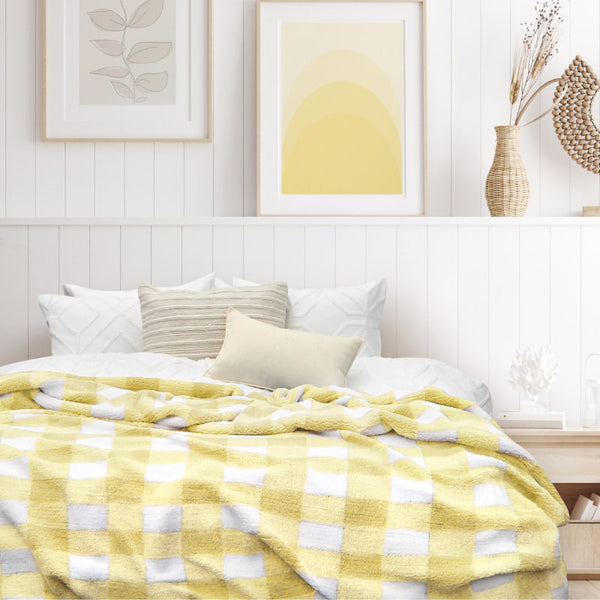 Explore on our yellow and white blanket featuring a large checkered pattern creates a bold visual grid, adding colour and pattern to the room's decor.