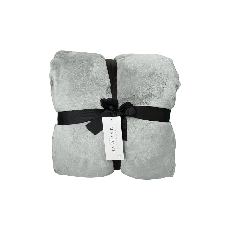 Front packaging of a luxurious mink touch blanket in a shade of silver featuring minimalist design, soft, velvety texture for cosy warmth. 