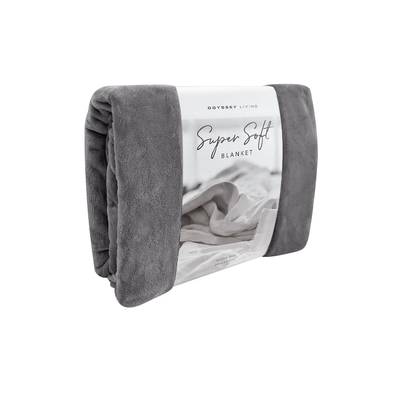 Side packaging details of the charcoal Odyssey Living Super Soft Blanket creating the perfect setting to cosy up in the luxurious comfort and warmth of the bed.