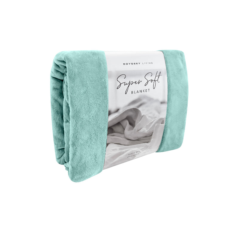 Side packaging details of the blue Odyssey Living Super Soft Blanket creating the perfect setting to cosy up in the luxurious comfort and warmth of the bed.