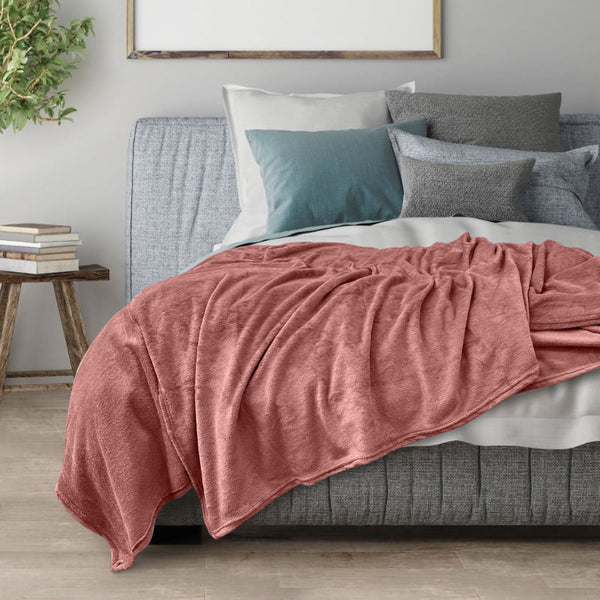 Transform your space into a cosy sanctuary with the red Odyssey Living Super Soft Blanket, designed to complement your mood and décor with its harmonious colour scheme.