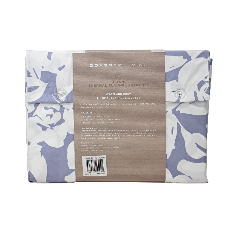Back packaging details of a lavender-toned bed sheets and pillows, adorned with a monochromatic white floral and foliage pattern, craft a serene and unique design.
