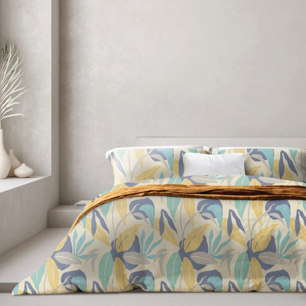 A modern bedroom with a blue and yellow quilt cover, featuring a botanical leaf pattern in soft tones, perfect for warmth and comfort.