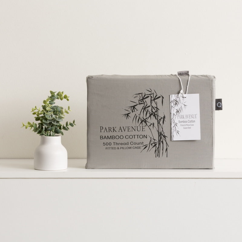alt="Charcoal packaging with plant and vase. Experience the extra soft bamboo cotton blend combo set with satin finish. Breathable, skin-friendly, and machine washable."