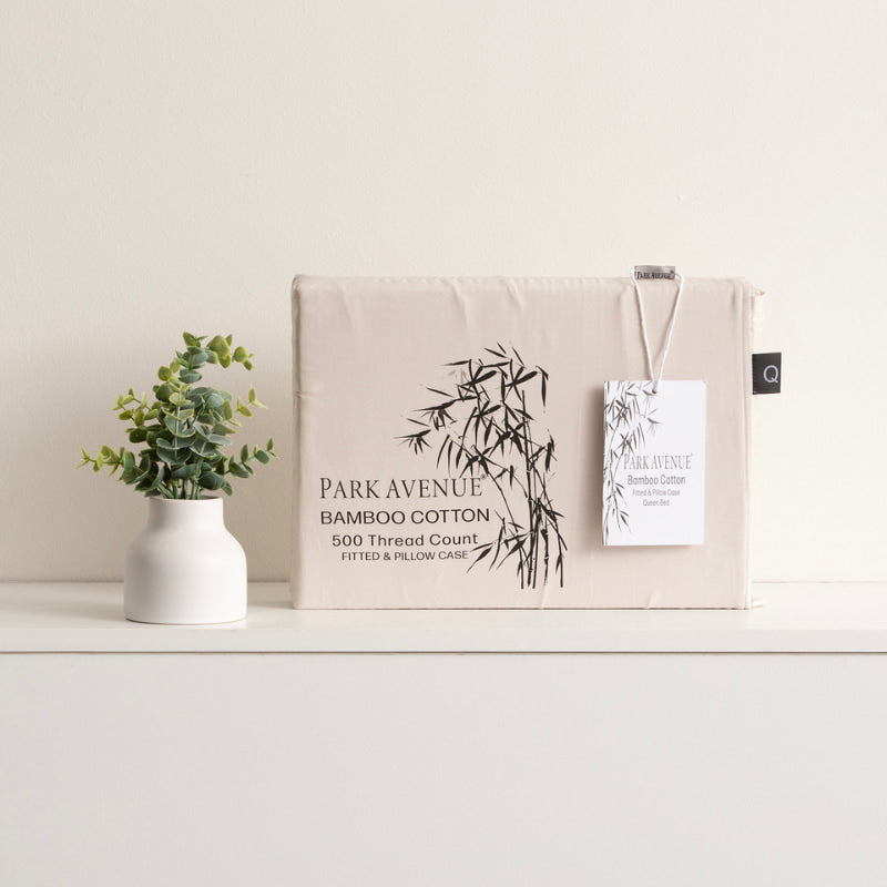 A shade of dove vase with a plant and a tag on it. Experience the soft and gentle extra soft bamboo cotton blend combo set.