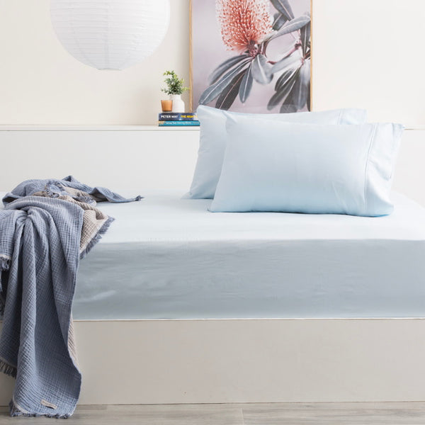 alt="Experience the ultimate comfort with this bamboo cotton fitted and pillowcase set. Breathable, skin-friendly, and machine washable. Light blue colour with a silky smooth finish."
