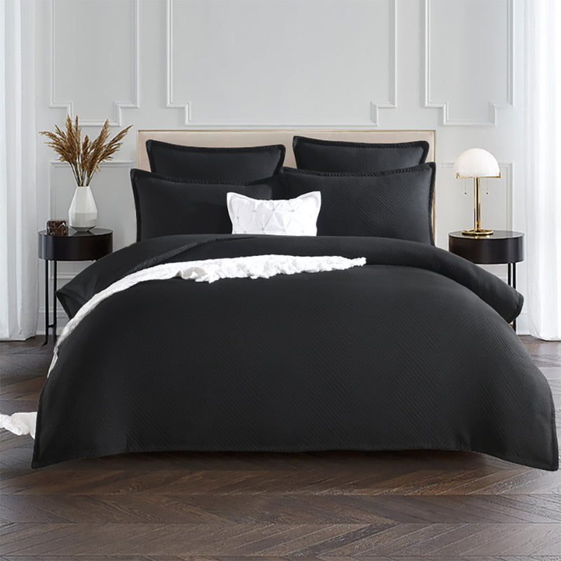 alt="Showcasing a european pillowcase featuring an embossed design with a sham edge deep black pairing with the quilt cover in a luxurious bedroom"