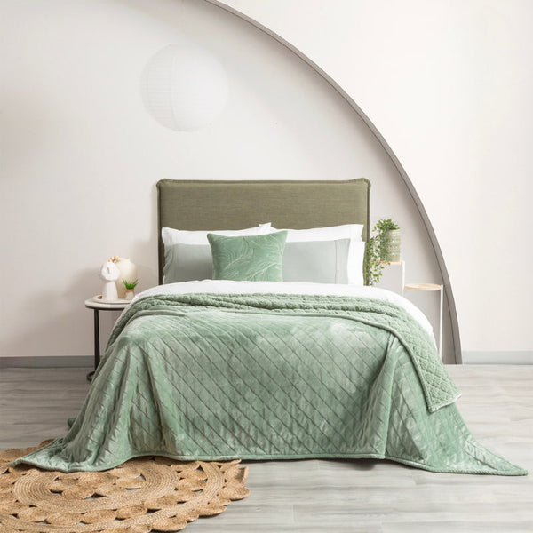 A cozy bedroom featuring eucalyptus colour ultra soft velvet blanket with a diamond pattern and clean edge.