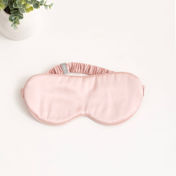 alt="A pink eye mask is made of 100% Mulberry Silk; it ensures a luxurious and comfortable sleep experience."
