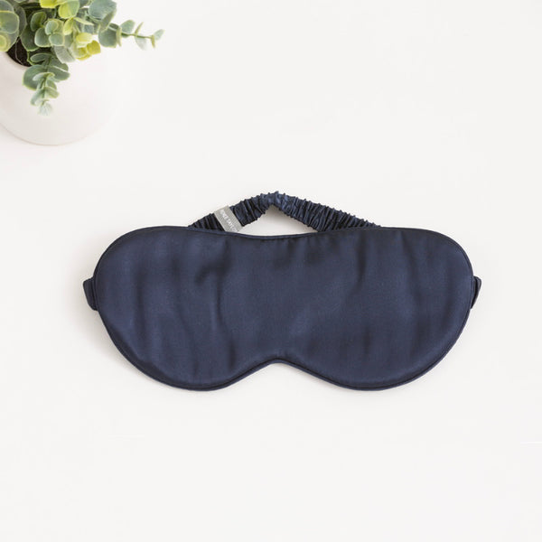 alt="Navy silk eye mask with 6 layers of soft padding, made from 100% pure mulberry silk. Gentle on skin, prevents wrinkles, and hydrates."