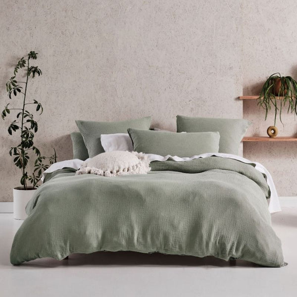alt="A triple-jacquard design quilt cover set in a cosy bedroom"