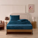 A modern bedroom with a beige upholstered bed and cream bedding exudes winter comfort, enhanced by the Morgan and Reid Winter Microplush Sheet Sets ultra-soft fabric, neutral decor, dried flowers, and light wood floors.