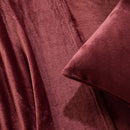 A modern bedroom with a beige upholstered bed and cream bedding exudes winter comfort, enhanced by the Morgan and Reid Winter Microplush Sheet Sets ultra-soft fabric, neutral decor, dried flowers, and light wood floors.