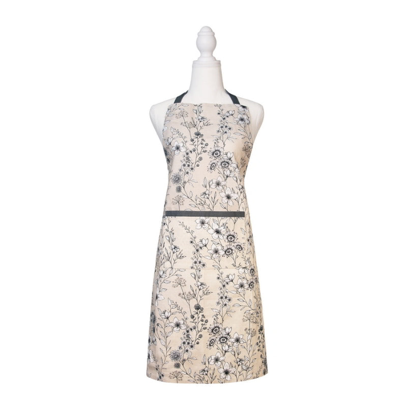 alt="Front details of a cream apron inspired by the blooming and blossoming of wild field flowers"