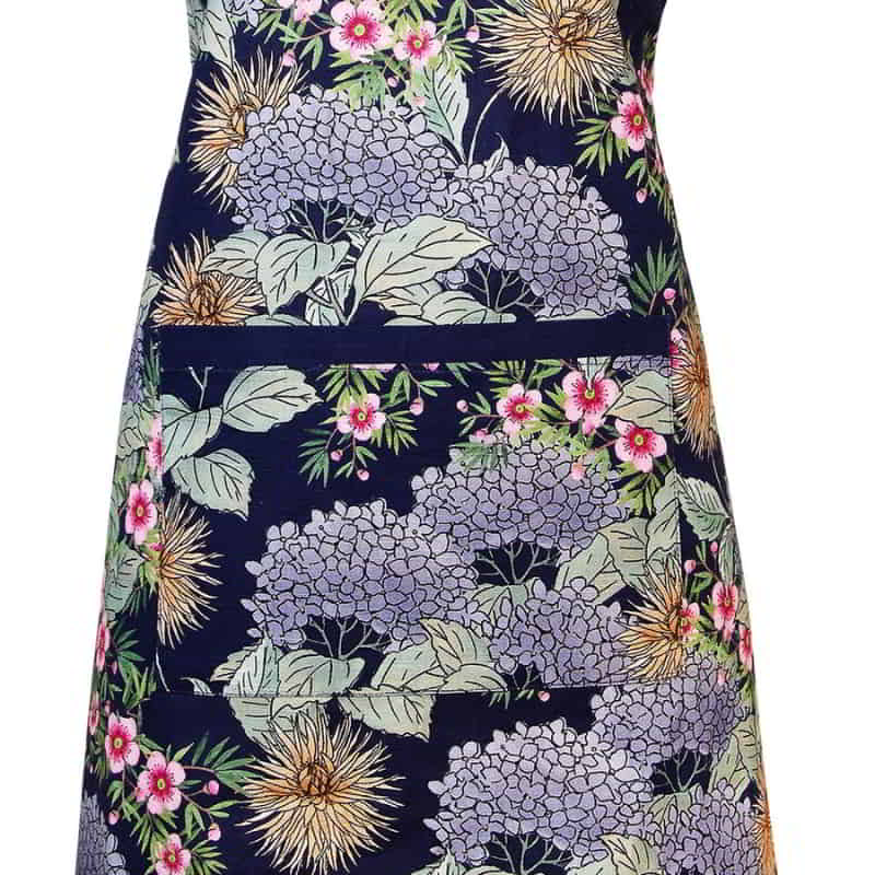alt="Close-up details of a navy apron featuring beautiful flowers and colours of an Australian summer garden"