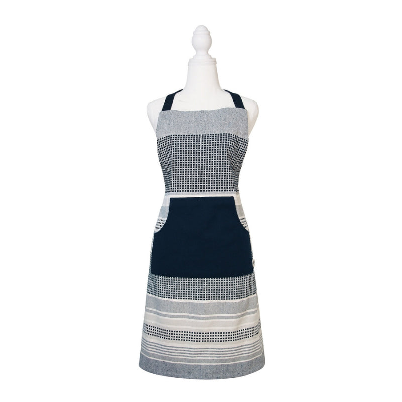 alt="A navy and grey apron features a combination of stripes and stitches in a neutral colour palette."