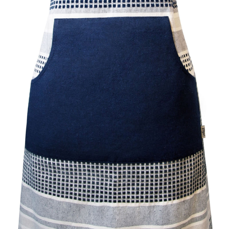 alt="Front details of a navy and grey apron featuring a combination of stripes and stitches in a neutral colour palette."