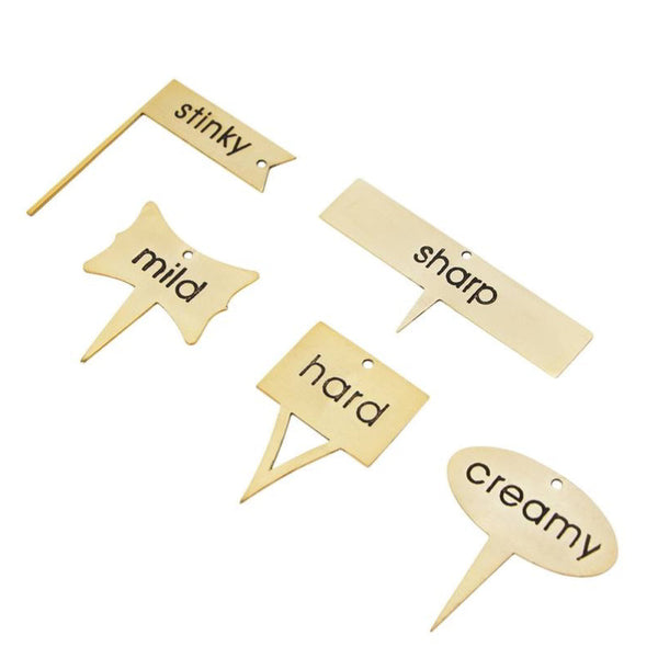 alt="Cheese markers set  engraved with Sharp, Hard, Mild, Stinky and Creamy, each in their own unique shape."