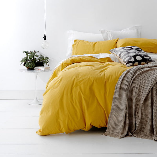 alt="A shade of yellow quilt cover is soft, stylish percale bedding set made of fine cotton percale. Timeless design for modern bedrooms."