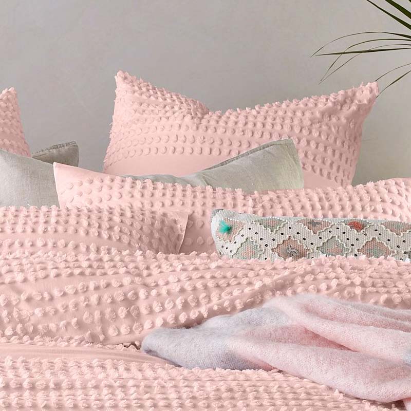 alt="Closer look of textured cotton quilt cover set with chenille dot pattern for added style and comfort paired with a European pillowcase."