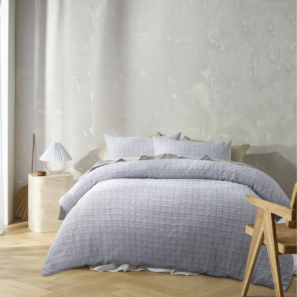 Full view of Augusta Grey Quilt Cover Set on a bed styled with soft neutral tones and layered pillows