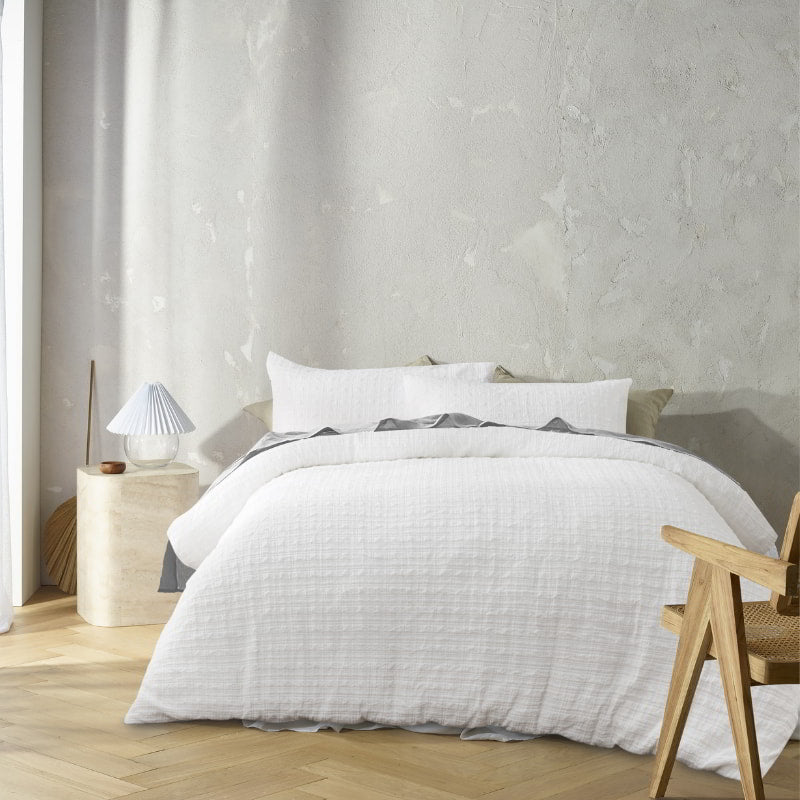 Augusta White Quilt Cover styled on bed with relaxed crinkled texture and neutral tones