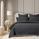 Bamboo cotton charcoal coverlet styled neatly on a bed with matching pillows