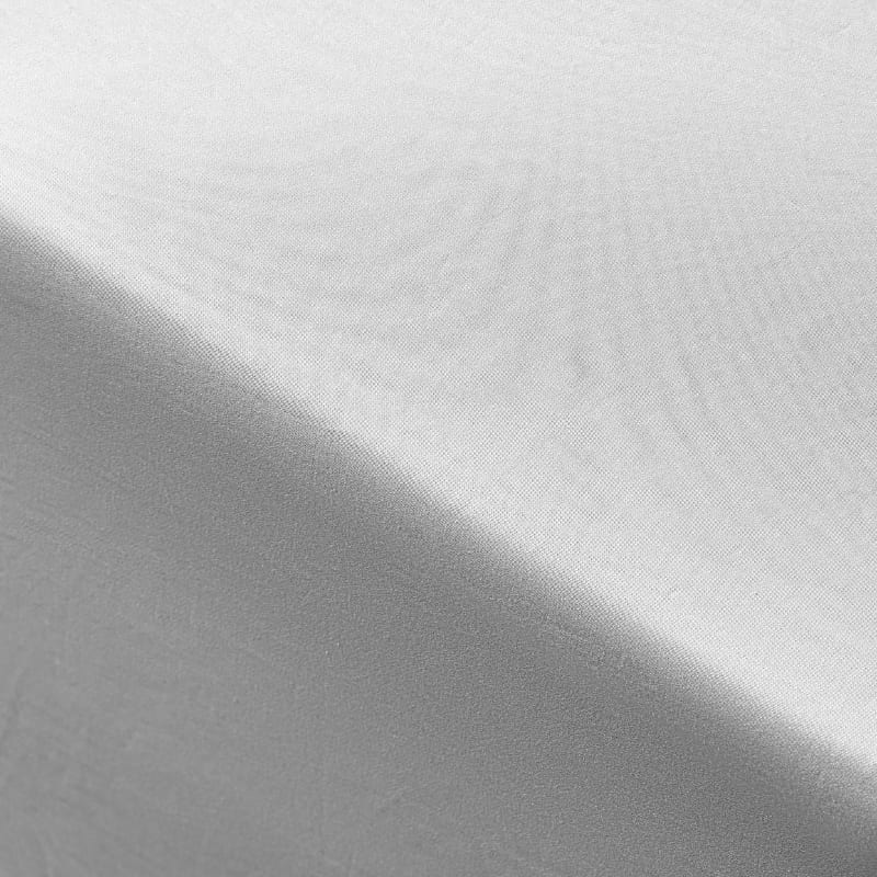 Close-up of soft, sateen weave texture in the grey coverlet with folded edges and smooth finish