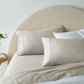 "A light brown, superior-quality cotton sheet set in a cosy bedroom"