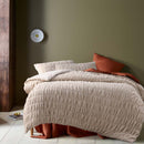 alt="A natural quilt cover set highlighted further with subtle ruching and texture"