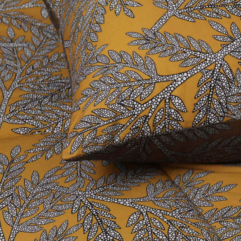 alt="Close up view of cotton printed comforter set with tropical clove leaves pattern"